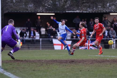 Enfields Sam Youngs (white) pulls the ball across the area