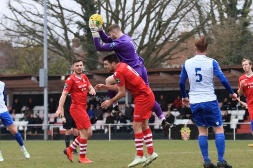 Hornchurch keeper Callum Chafer climbs above teammate Sean Marks to catch a cross