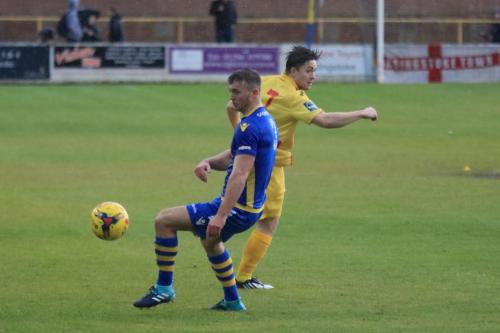 Basingstokes Robert Gerrard(L) and Enfields Lewis Taaffe