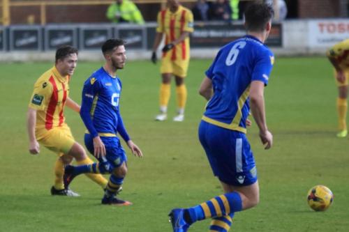 Enfields Lewis Taaffe (L) plays the ball forward