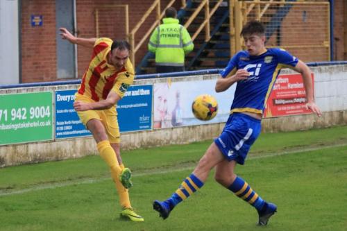Enfields Matt Johnson (L) crosses past Dan Baylisss challenge