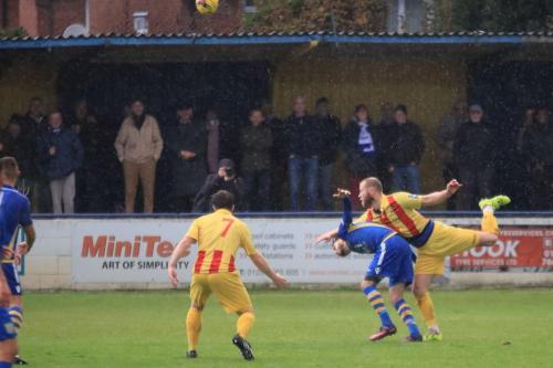 Enfields Sam Hatton (R) heads clear from Sam Deadfield