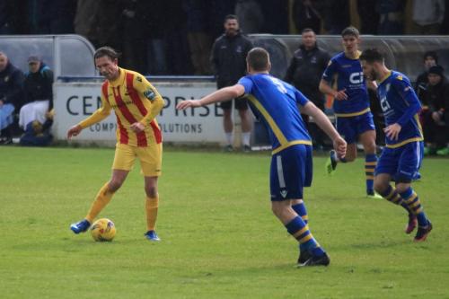 Enfields Sam Youngs (L) plays tha ball forward