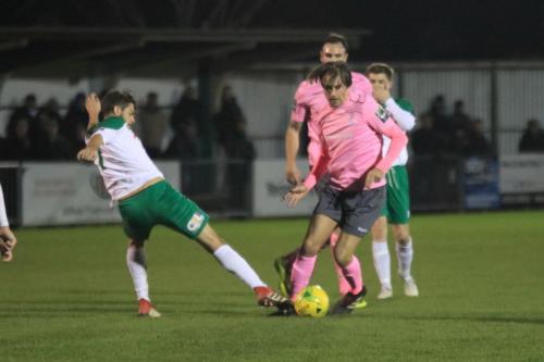 Bognors Harvey Whyte (L) challenges Sam Youngs