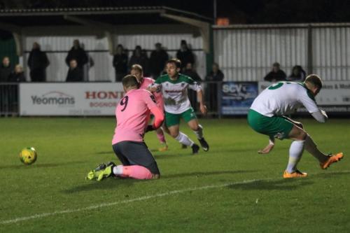 Enfields Billy Bricknell (9) and Bognors Chad Field are wrong-footed by Aaronm Greenes deflected shot