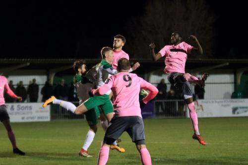 Enfields Muhammadu Faal (R) wins a header