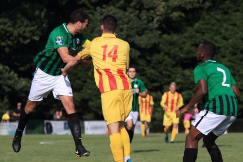 Burgess Hills Gary Elphick )L) heads clear from Brandon Adams