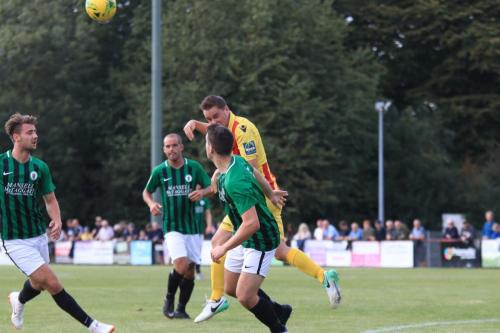 Enfields Liam Hope (yellow red) wins a header