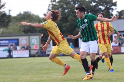 Enfields Sam Chaney (L) receives a shove in the back from Connor Tighe