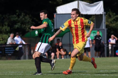 Enfields Sam Chaney chases a back-pass from Gary Elphick (L)