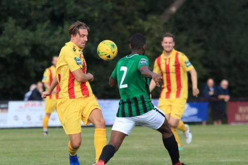 Enfields Sam Youngs (L) knocks the ball past Ibrahim Diallo