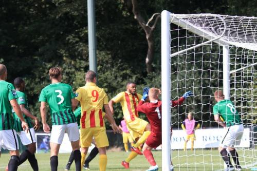 Taofiq Olomowewe puts Enfield 2-0 up despite the efforts of Pat Harding (8) on the post