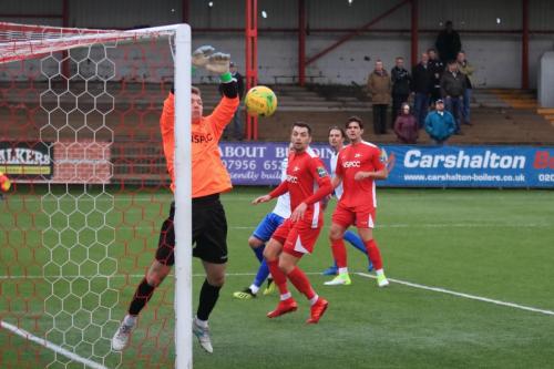Carshalton keeper Patrick Ohman parries the ball at his near post
