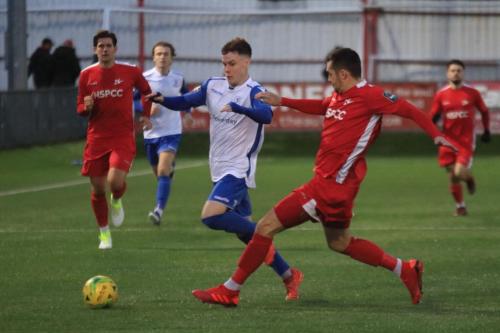 Carshaltons Danny Dudley (red) tackles Sam Chaney