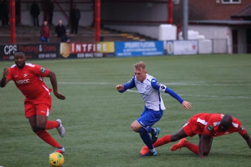 Enfields Ryan Blackman and Carshaltons Peter Adeniyi (R) and Daniel Pappoe