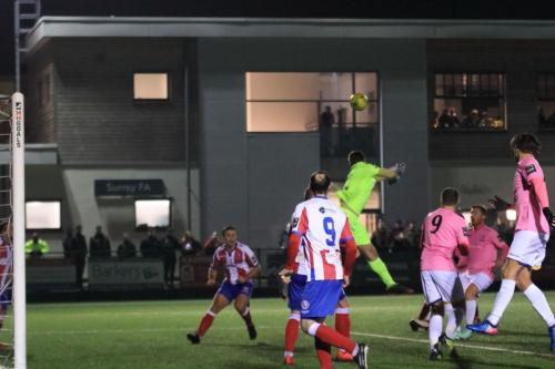 Dorking keeper Slavomir Huk misses a cross but Enfield cant take advantage