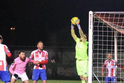 Dorking keeper Slavomir Huk saves a header from Sam Youngs