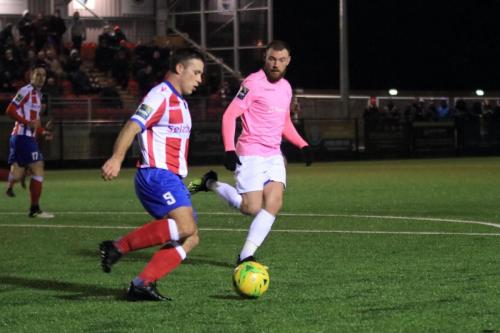 Dorkings Luke Moore (L) clears from Billy Bricknell