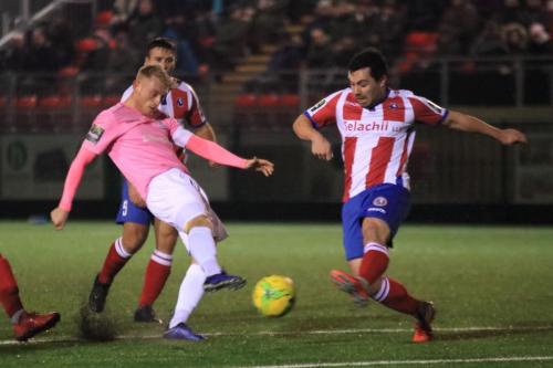 Dorkings Matt Briggs (R) blocks Ryan Blackmans shot