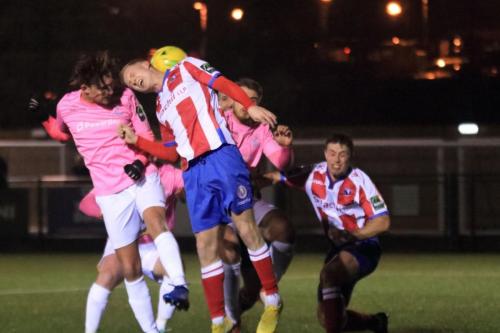 Enfields Sam Youngs (L) beats Sam Beard to get a header on target