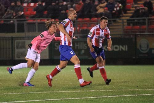 Enfields Sam Youngs shoots over watched by Sami el-Abd (centre) and David Ray