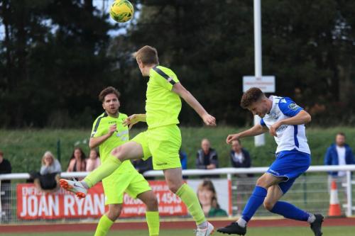 Bedfords Mason Watkins-Clark (centre) heads clear from Bilal Sayoud