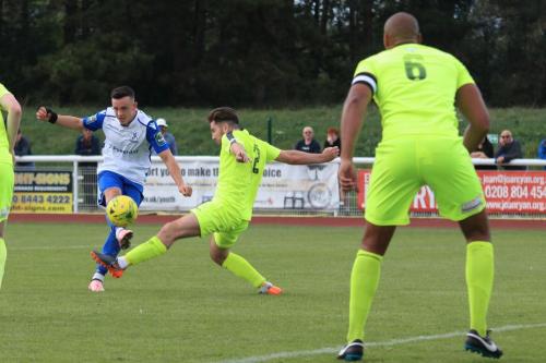 Enfields Brandon Adams (L) shoots past Brett Longdens block but off target