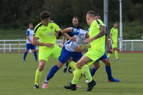 Enfields Brandon Adams tries to run between Ollie Swain (L) and  Craig Daniel