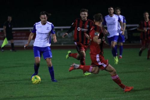Enfields Sam Youngs (L) runs at Jake Gould