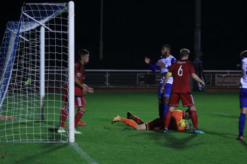 Regent keeper James Bradbrook collects at the feet of Taofiq Olomowewe