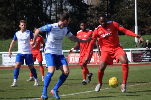 Carshaltons Daniel Pappoe (R) clears from Matt Johnson