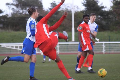 Carshaltons Daniel Pappoe (red) clears from Sam Youngs