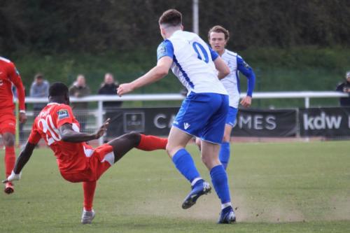 Carshaltons Jacob Mendy (20) clears from Josh Davison