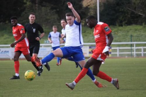 Carshaltons Jacob Mendy (R) clears from Sam Chaney