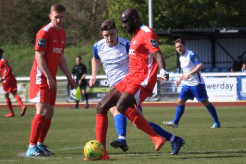 Carshaltons Peter Adeniyi (R) clears from Josh Davison watched by Luke Read