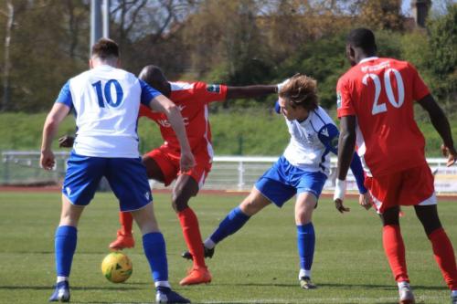 Carshaltons Peter Adeniyi (red, L) holds off Mickey Parcell