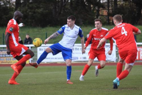 Enfields Sam Chaney (white) challenges Peter Adeniyi (L)