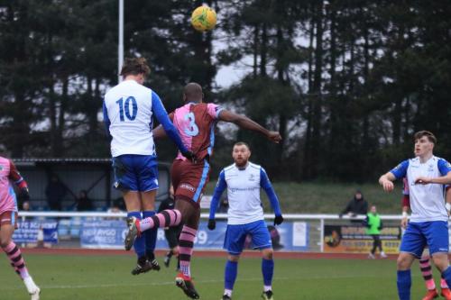 Enfields Sam Youngs (10) wins a header against Hakeem Adelakun