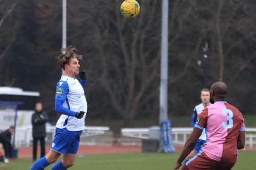 Enfields Sam Youngs (L) heads the ball across the penalty box