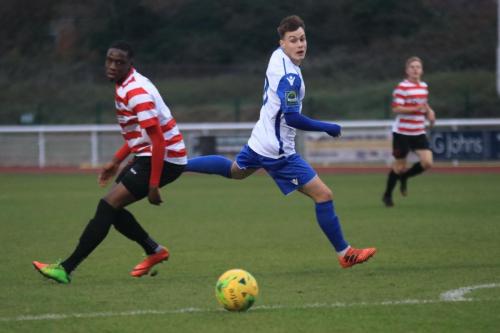 Enfields Sam Chaney (R) flicks the ball past Temi Eweka
