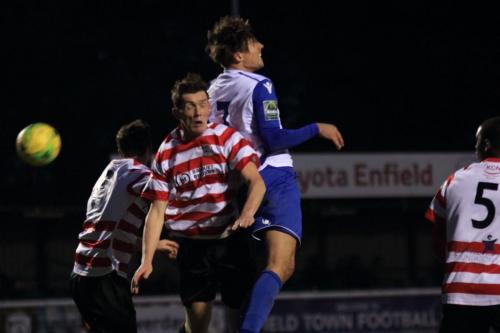 Enfields Sam Youngs (white blue) challenges Connor Dymond