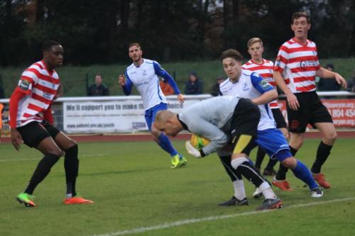 Kingstonian keeper Rob Tolfrey collects ahead of Lewis Taaffe