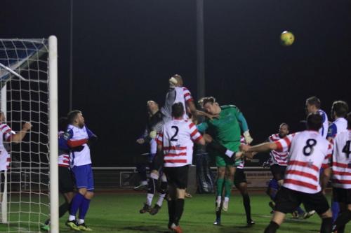 Kingstonian keeper Rob Tolfrey punches clear under pressure from his opposite number Joe Wright (green)