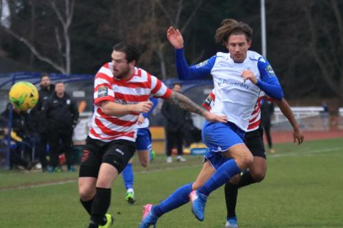 Kingstonians Aaron Lamont (red) challenges Sam Youngs