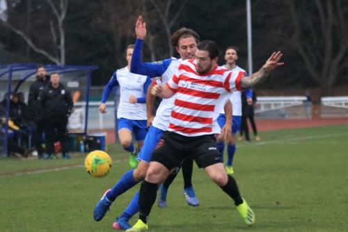 Kingstonians Aaron Lamont (red) challenges Sam Youngsx