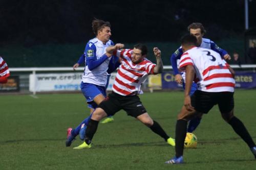 Kingstonians Aaron Lamont (red white) challenges Sam Youngsx