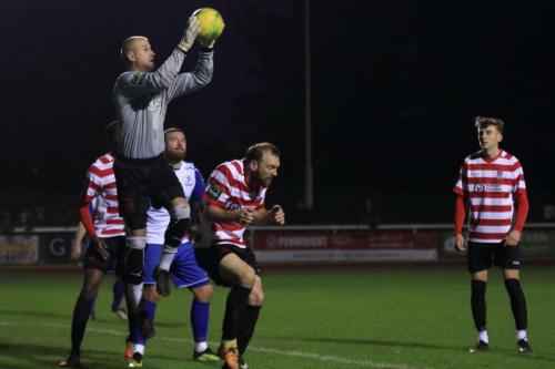 Kingstonians Jay Gasson (red white, centre) responds to a call from his keeper Rob Tolfrey