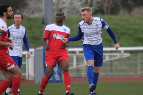 Enfield captain Ryan Blackman (R) heads the ball forward