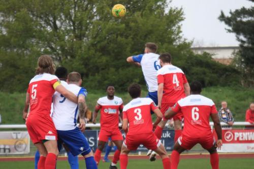 Enfields Dan Rumens (white 6) heads on goal