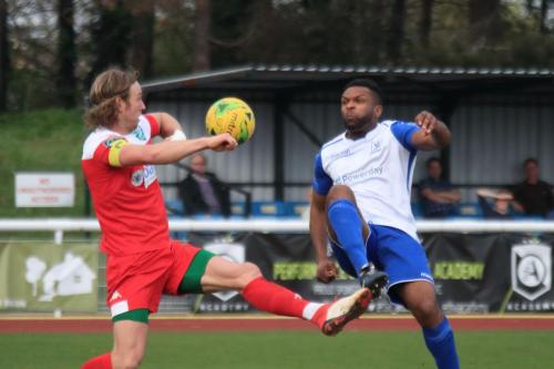 Enfields Kezie Ibe (R) flicks the ball past Will Salmon to set up a shooting chance